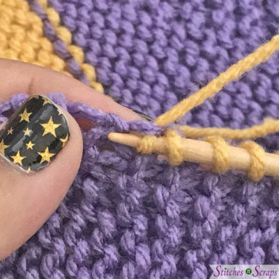 Picking up and knitting a stitch, English style. Tutorial on StitchesnScraps.com