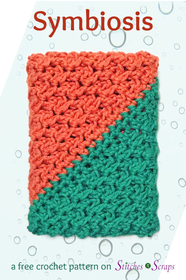 A diagonally crocheted washcloth with coral on one side and teal on the other. Symbiosis, a free crochet pattern on Stitches n Scraps