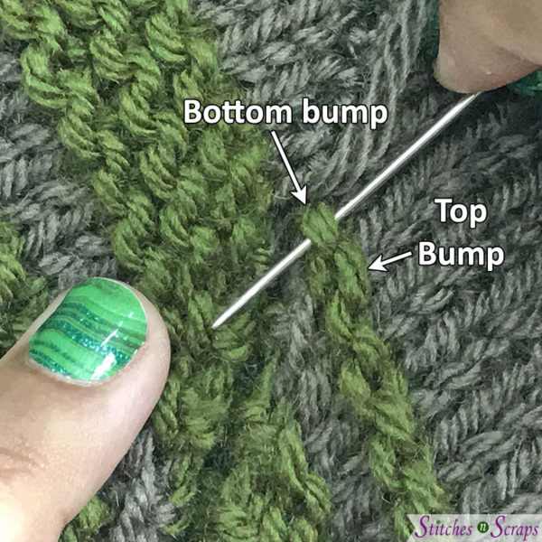 Taupe and green striped fabric. Hands inserting a yarn needle through a loop on garter stitch a the edge of one piece. Text shows "top bump" and "bottom bump" of the garter stitch ridge