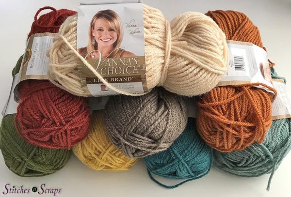 A pile of partially used skeins of Vanna's Choice yarn, in various colors