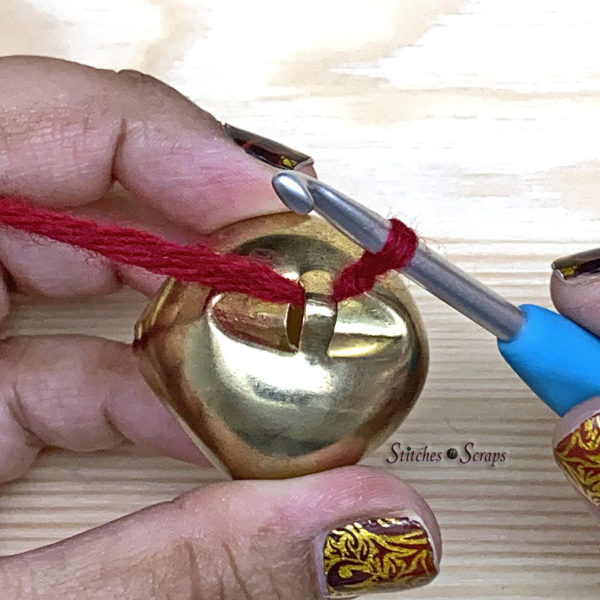 Pulling a slip knot through a large jingle bell