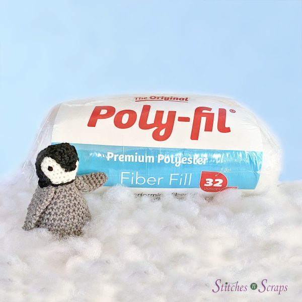 Playful the Baby Penguin with a bag of PolyFil Fiber Fill