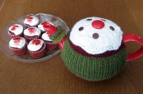 March tea cozy next to a plate of mini cupcakes