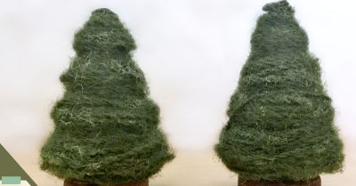 2 wooden trees wrapped in yarn. In the corner is the same tree decorated with a red pom pom and silver thread garland - quick and easy holiday craft tutorial on Stitches n Scraps