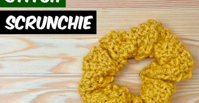 A yellow, textured scrunchie on a wood table. Text: Rosette Stitch Scrunchie - Free Knitting Pattern on StitchesnScraps.com