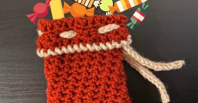 A crochet bag with pictures of candy coming out of it. Textured Treat Bag - a free crochet pattern on Stitches n Scraps