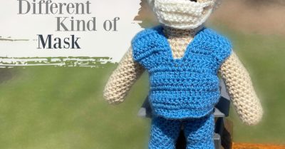 Superhero doll in scrubs with a medical mask and cap. These days, Superheroes wear a different kind of mask. Free crochet pattern on StitchesnScraps
