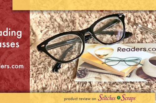 Reading glasses from readers.com, on a fur yarn background, next to a readers.com business card and a crochet hook.