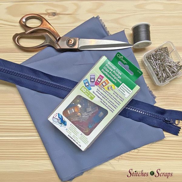 lining supplies for bag 3 - showing scissors, thread, needle, pins, clips, fabric, and a zipper