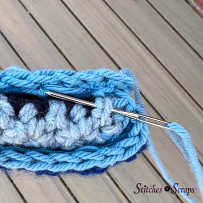 bring needle horizontally through adjacent stitch on body