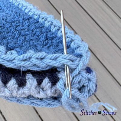 bring needle up in same stitch on flap